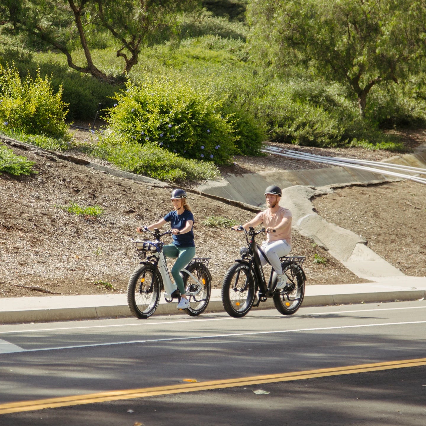 Man and woman riding Kingbull Discover electric bikes together, showing versatile design for all riders