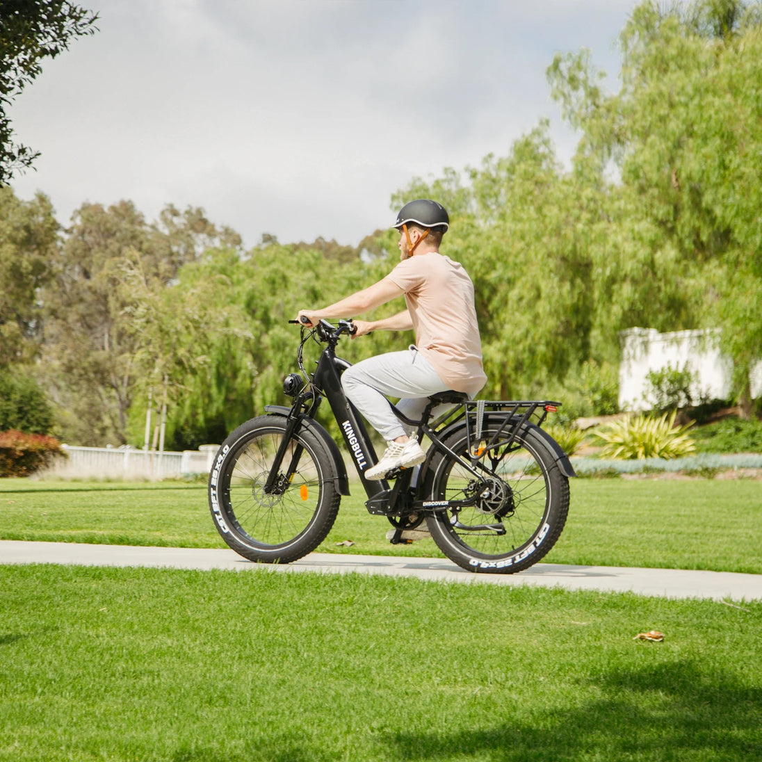Man riding Kingbull Black Discover electric bike in outdoor setting showcasing versatility