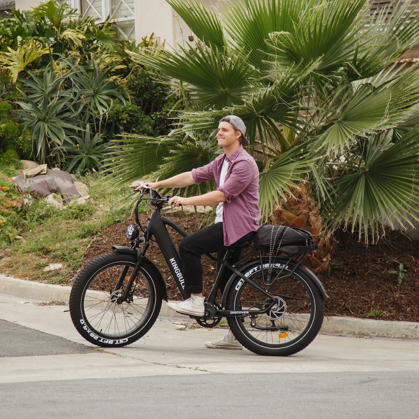 Man sitting on Kingbull Discover electric bike while stationary, showing comfortable seating position