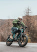 a man rides a green engwe m20 electric bike