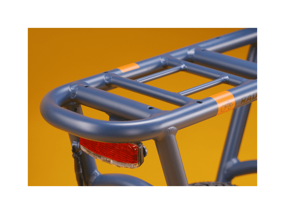 A blue electric bike rack and red taillight against a gold background.