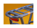 A blue electric bike rack and red taillight against a gold background.