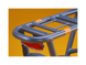 A blue electric bike rack and red taillight against a gold background.