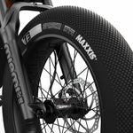 Close-up view of the MAXXIS SuperSucker tires and branded front fork decals on the SUPER73-Z Miami SE Legacy Series ebike in astro orange @color_astro orange